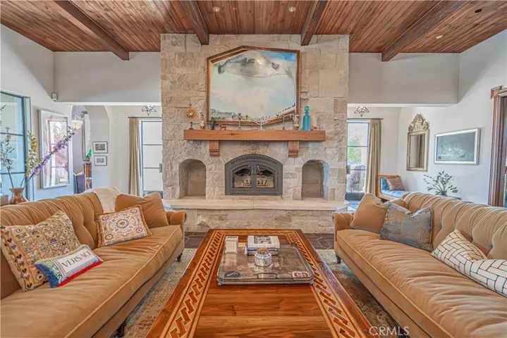 A stone wood-burning fireplace crafted from genuine limestone, featuring visible fossils that make it a stunning work of art all on its own.