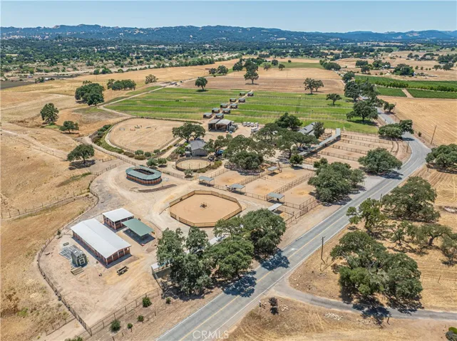 An equestrian lover’s dream come true — featuring a professionally designed jumping and dressage arena, multiple barns, horse walkers, a lunging ring, and every amenity needed for a premier luxury horse facility.