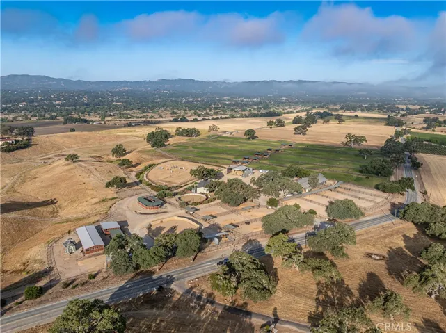 An aerial view of the equestrian area reveals its ideal placement — set far from the main house, pool house, and  barn/shop. It even features its own private, gated entrance for added convenience and privacy.