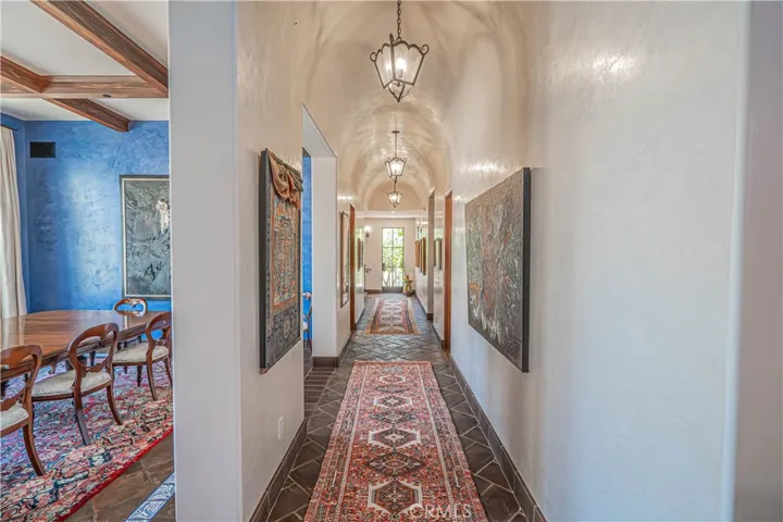 Venetian plaster walls and barrel-vaulted ceilings line the hallway, adding a timeless architectural touch and elegant texture throughout.