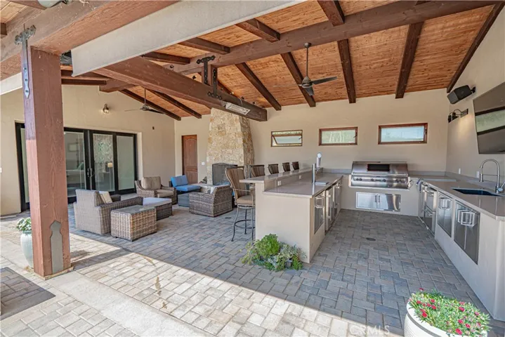 A closer look at the covered BBQ and seating area located just off the guest room, perfect for outdoor relaxation and entertaining.