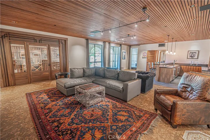 Searching for the perfect spot to host? This indoor space has it all — a cozy theater, wine cellar, and a bar ready for any gathering. The lower level also offers an office/den and a bathroom with a stunning shower, adding both functionality and luxury.