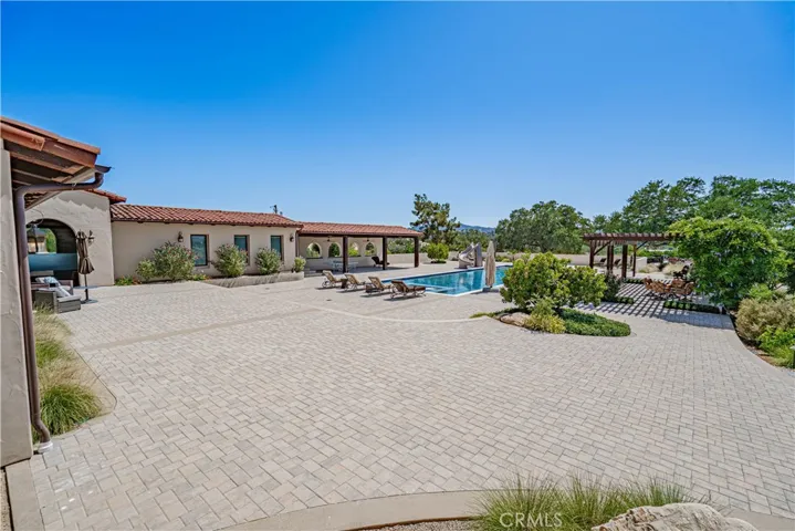 The beautiful pavers continue seamlessly around the pool area, creating a space that is both expansive and inviting.