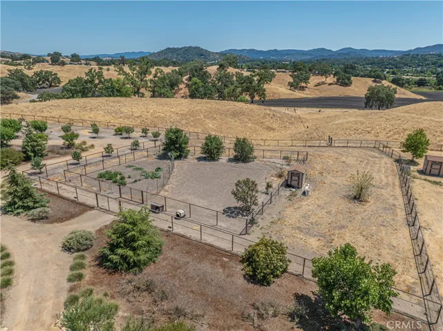 A generous fenced dog run is located just off the barn/shop area.