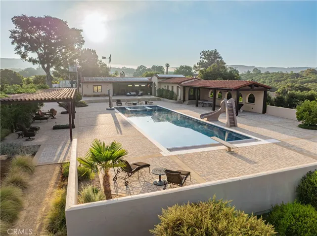 Host unforgettable events around the beautiful 75' x 23' pool, complete with a slide, diving board, and a spa seamlessly built into the pool.