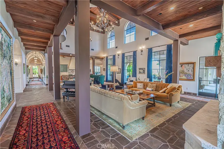Expansive wood ceilings extend throughout the home, beautifully paired with thoughtfully placed lighting and designer fixtures — all controlled by a state-of-the-art Lutron lighting system.