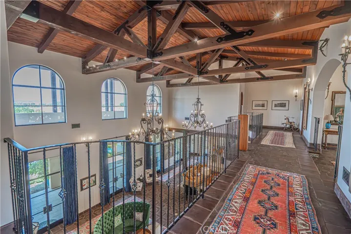 Stunning wood beams stretch the length of the living area, creating a striking architectural statement and adding warmth and character to the space.