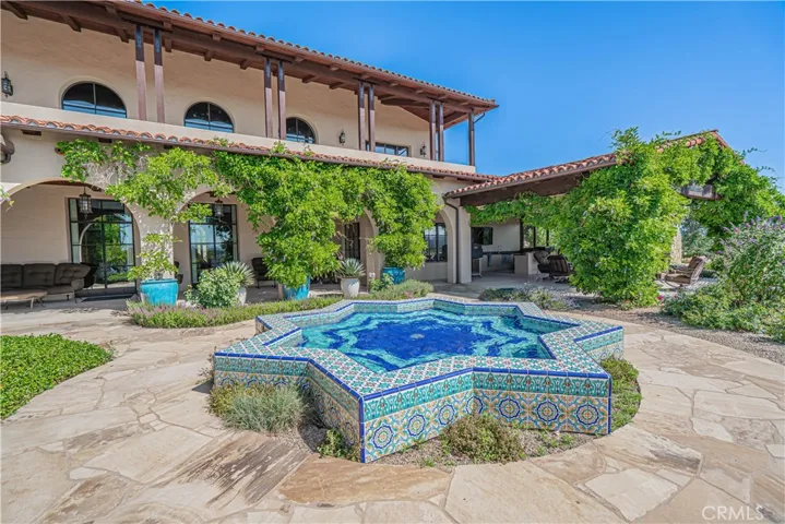 A striking Moorish star fountain adds timeless elegance to the private courtyard.