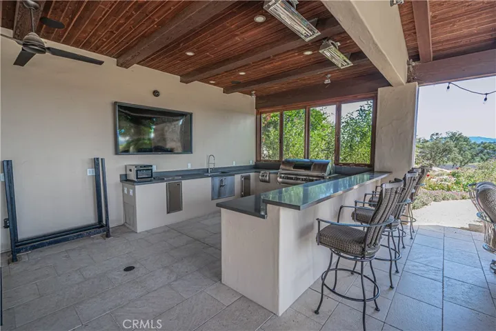 Enjoy year-round outdoor dining with a built-in BBQ and heated lamps.