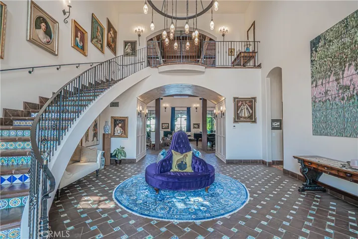Upon entering, a magnificent entryway invites you in, with sweeping stairs ascending to an expansive, palatial upper level.