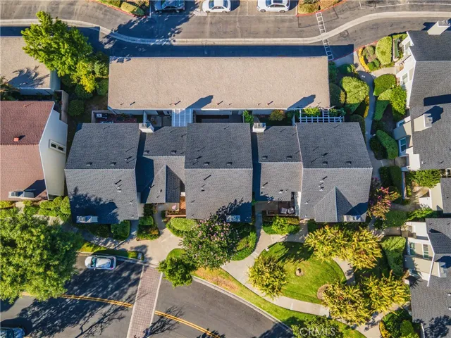 House is 2nd from the right.  The neighborhood has lots of lush trees, bushes and flowering plants.