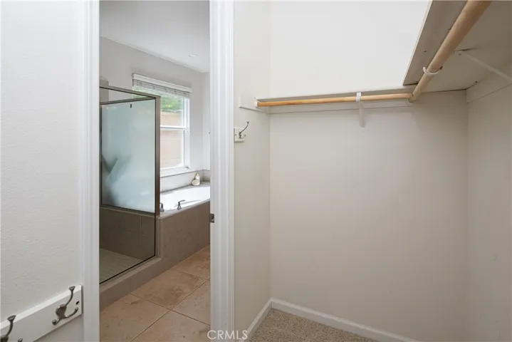 Large walk-in closet behind the attached bathroom.