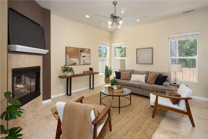 Bright, open with a fireplace and a TV in the family room