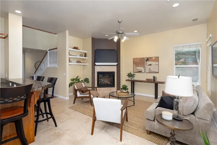 The family room is open to the kitchen and hallway with lots of light.