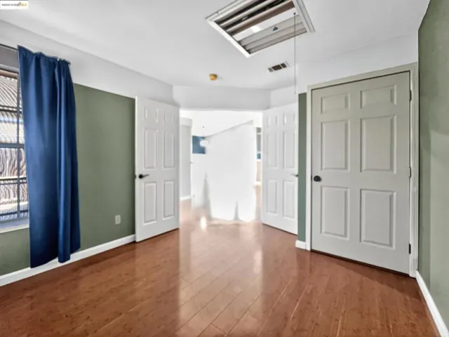 Spare room featuring wood finished floors