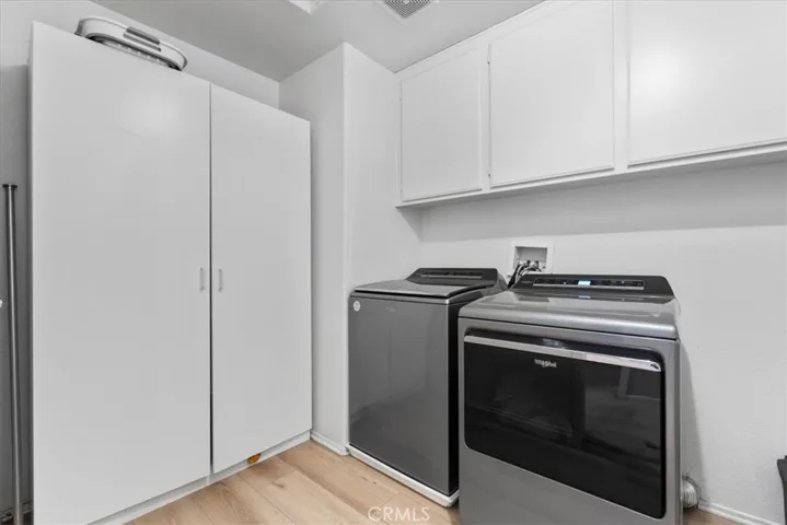 Upstairs laundry room with cabinets