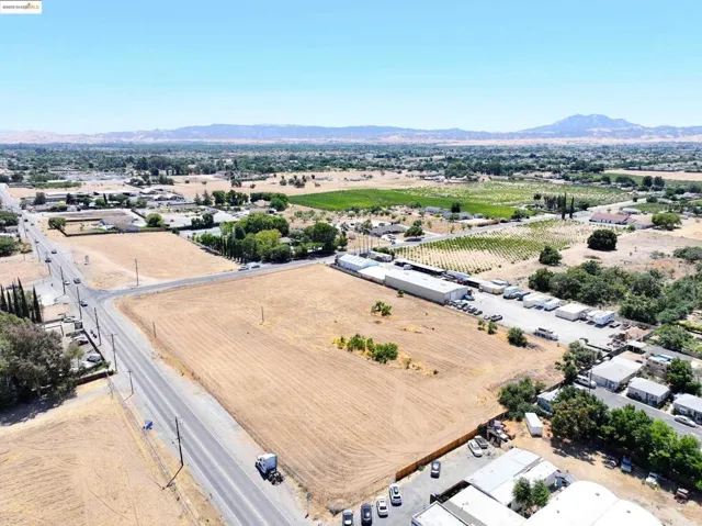 Aerial view of sparsely populated area featuring a mountainous background