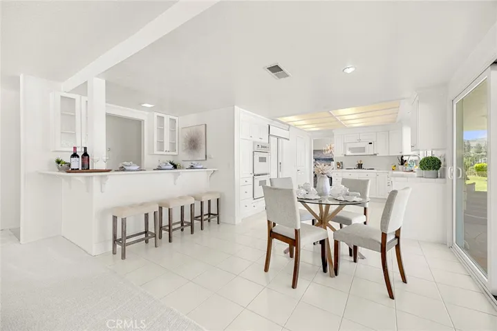 View of the kitchen nook area and wet bar with lots of space for entertaining