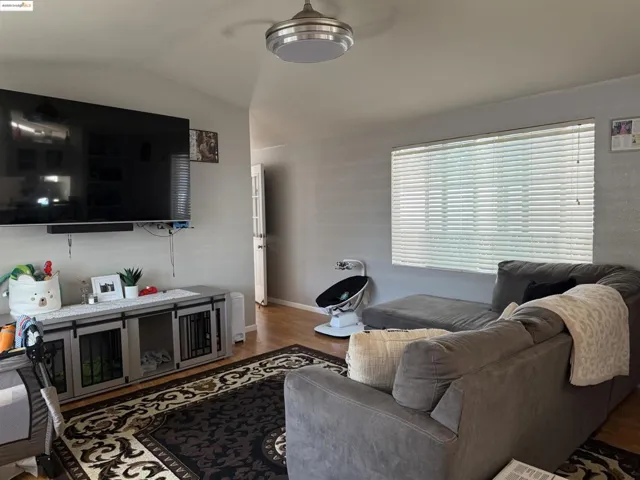 Living room featuring vaulted ceiling and light wood finished floors
