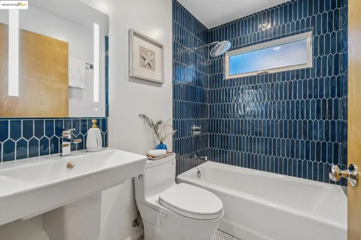 Full bathroom featuring tub / shower combination and tasteful backsplash