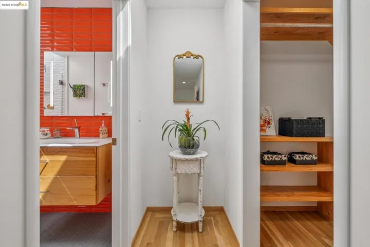 Hallway with a sink and wood finished floors