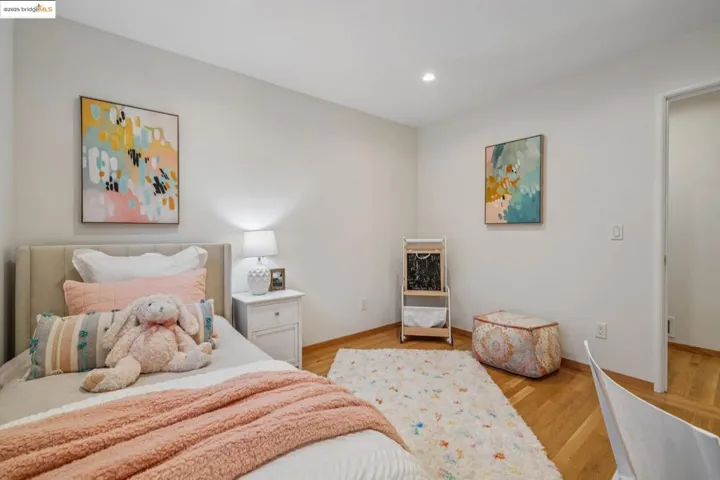 Bedroom with light wood finished floors and recessed lighting