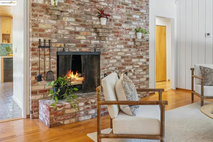 Living area featuring hardwood / wood-style flooring and a brick fireplace