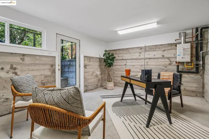Office space featuring concrete floors and water heater