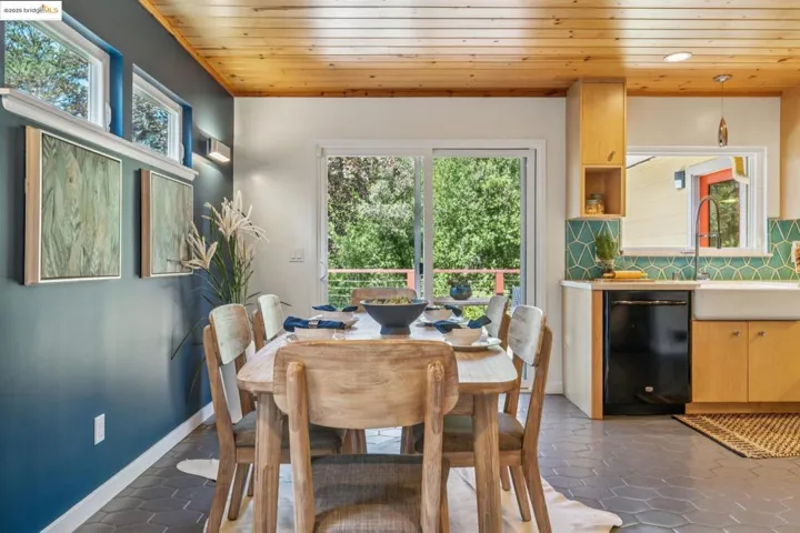 Dining area with wood ceiling and dark tile patterned floors
