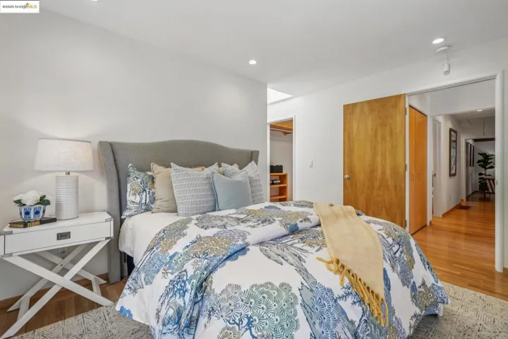 Bedroom featuring attic access, wood finished floors, and recessed lighting