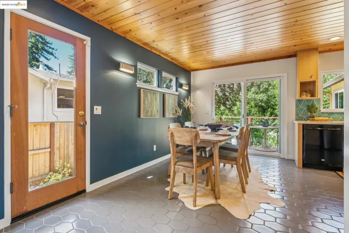 Dining space featuring wooden ceiling and baseboards