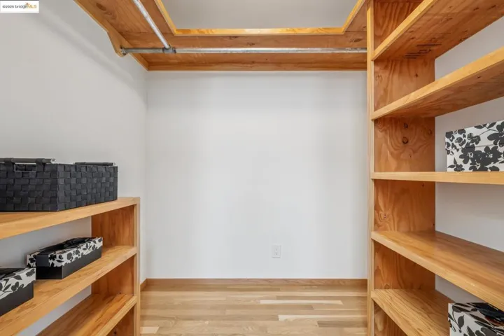 Spacious closet featuring wood finished floors