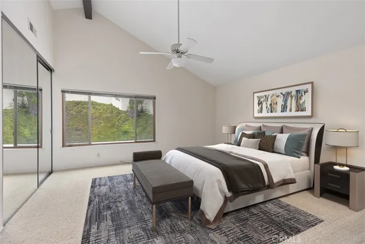 Primary bedroom with wall length closet and view of the private backyard.