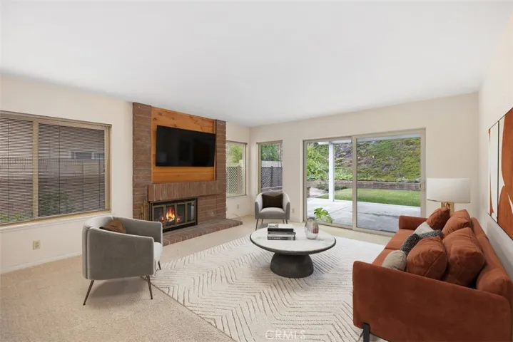 Large family room with fireplace.
Note: This room is virtually stagged.