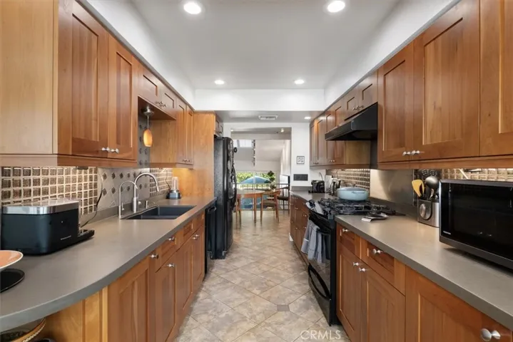 Kitchen with custom cabinetry and Silestone counters