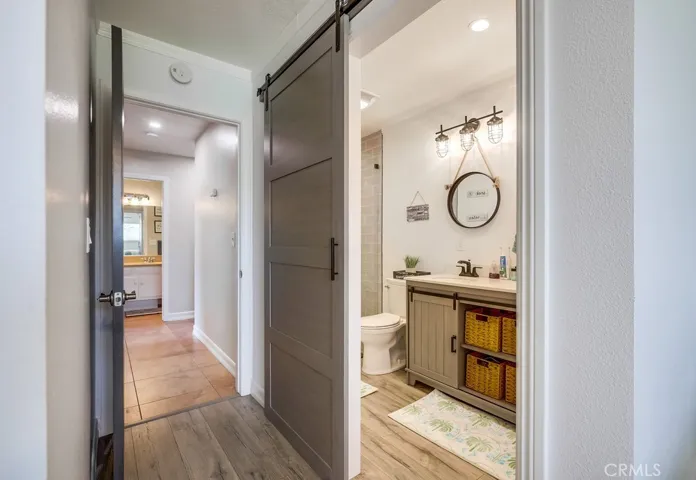 View from primary bedroom into primary bathroom and hallway.