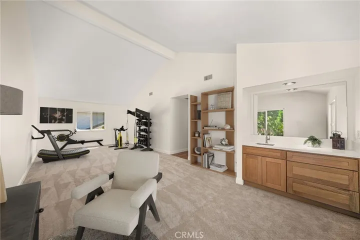 Virtually Staged Bonus Room: Virtually staged as an office with work out equipment.