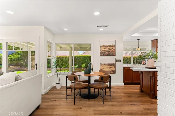 Dining area and partial view of kitchen, covered patio and backyard.