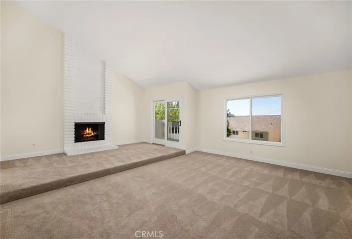 Primary Suite featuring the third of 3 fireplaces, sitting area and balcony.