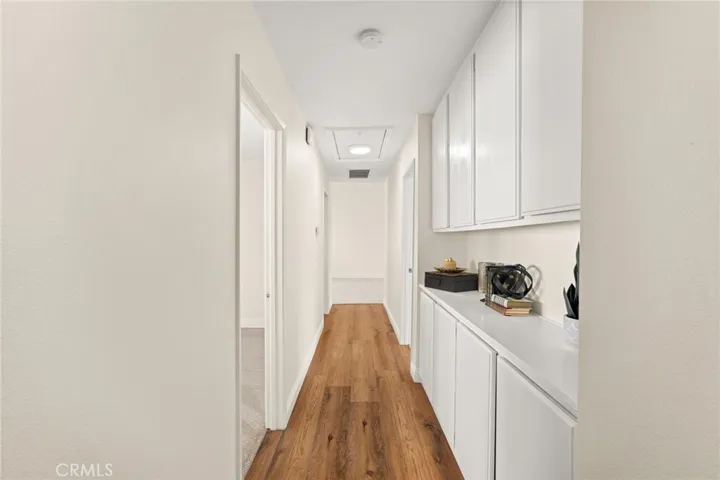 Upstairs hallway with additional storage. Pull down access for attic storage.