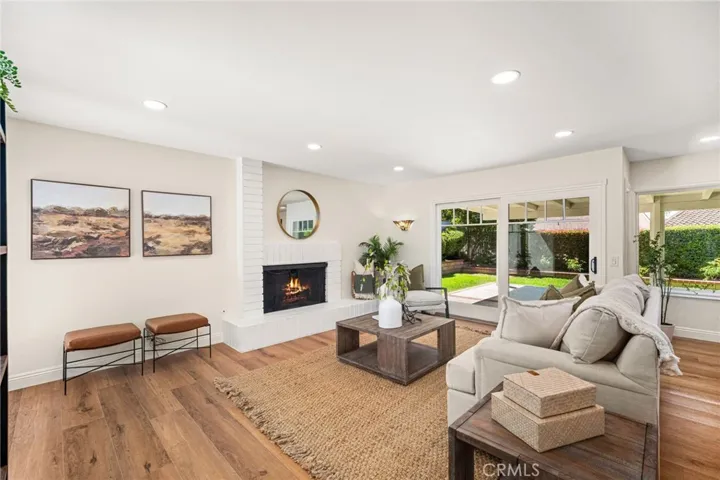 Great Room with the second of 3 fireplaces. Slider leading out to the covered patio and backyard.