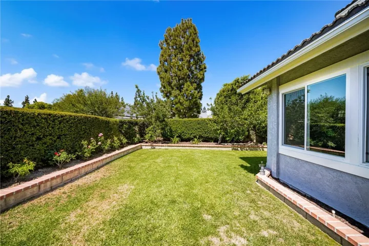 Backyard with lawn and flowerbeds.