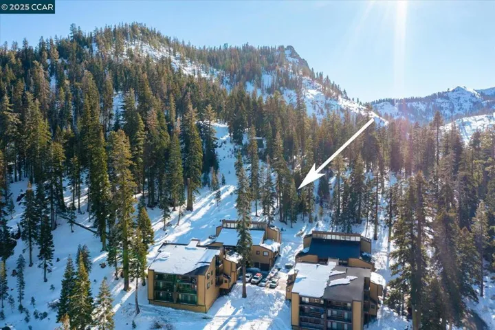 Tucked against the forested mountainside, this residence offers direct proximity to trails and slopes in a serene alpine setting.