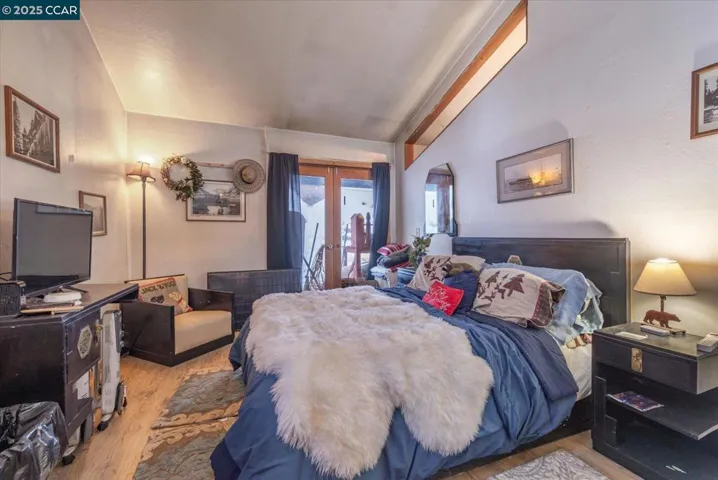 Spacious guest bedroom with private patio access, vaulted ceilings, and plenty of natural light.