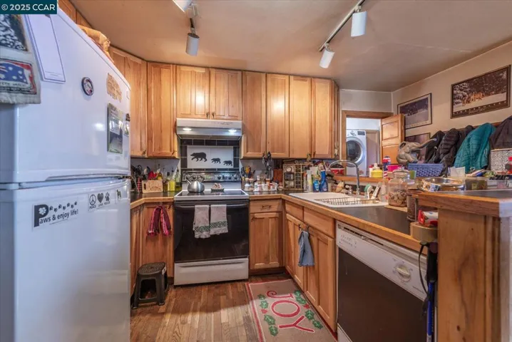 A functional kitchen with wood cabinetry, ample storage, and direct access to the living space, ready for après-ski gatherings.