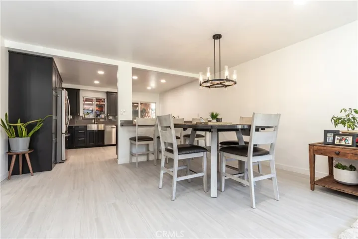 Open floor plan with expandable dining area and updated chandelier.