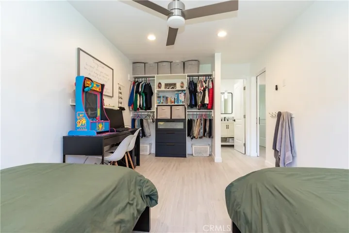 Open closet with organizers in the secondary bedroom.