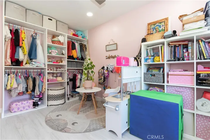 Third bedroom open closet with organizers and 4 hanging spaces.
