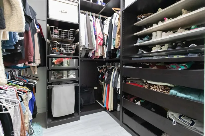 Closet organizers in the primary walk-in closet.