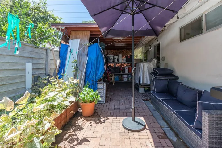 Solid patio cover over part of the patio allows for laundry area.
